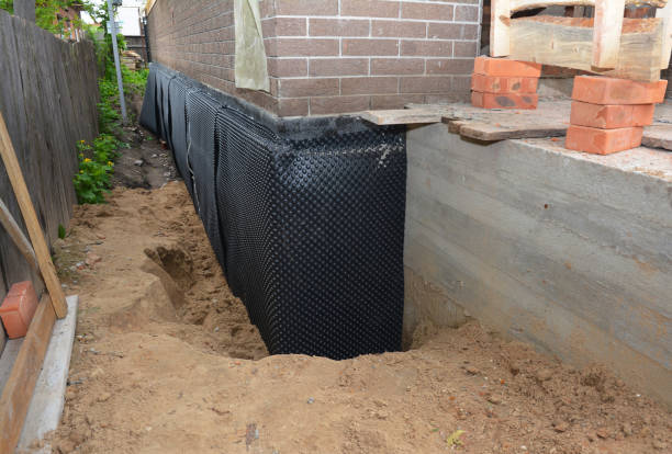 Happy homeowners after waterproofing job in New Troy